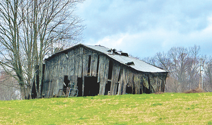 Old barns were built to last, but they are gradually disappearing from the landscape. This weathered barn is off Tate Springs Road in Powell Valley.  JOHN SCHOOLCRAFT PHOTO